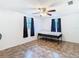 Bedroom with hard surface flooring, ceiling fan, and view of the backyard at 14034 Water Tower Dr, Hudson, FL 34667