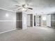 Large bedroom with neutral carpet and paint, multiple closets, and access to the bathroom at 14034 Water Tower Dr, Hudson, FL 34667