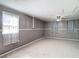 This bedroom boasts light neutral paint and carpet, and bright windows with stylish curtains at 14034 Water Tower Dr, Hudson, FL 34667
