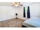Bright bedroom with hardwood floors, ceiling fan, and minimalist decor at 14034 Water Tower Dr, Hudson, FL 34667