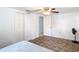 Bedroom featuring hardwood floors and double closets, complemented by a ceiling fan at 14034 Water Tower Dr, Hudson, FL 34667