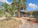 Front of house with Palm trees and landscaped yard at 14034 Water Tower Dr, Hudson, FL 34667