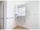 Laundry room with tile floors, a large window with pretty patterned curtain at 14034 Water Tower Dr, Hudson, FL 34667