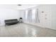 Bright living room featuring tile flooring, neutral walls, and natural light from the front door windows at 14034 Water Tower Dr, Hudson, FL 34667