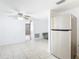 Open-concept floorplan features tile flooring, stainless steel refrigerator, and neutral paint at 14034 Water Tower Dr, Hudson, FL 34667