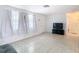 Bright living room featuring tile flooring, crisp white walls, and multiple windows for natural light at 14034 Water Tower Dr, Hudson, FL 34667