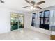 View of the sunroom with ceiling fans and natural light from the windows, with views of the outdoors at 14034 Water Tower Dr, Hudson, FL 34667