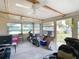 Sunroom offering multiple ceiling fans, natural light from the windows, and outdoor access at 14034 Water Tower Dr, Hudson, FL 34667