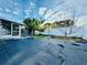 Large backyard with screened porch at 1415 Weyford Ln, Holiday, FL 34691
