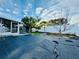 Large backyard features a shed and screened patio at 1415 Weyford Ln, Holiday, FL 34691