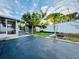 Spacious backyard with shed, screened patio, and lush landscaping at 1415 Weyford Ln, Holiday, FL 34691
