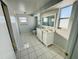 Bathroom boasts a double vanity and updated fixtures at 1415 Weyford Ln, Holiday, FL 34691