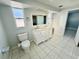 Double vanity bathroom with white cabinets at 1415 Weyford Ln, Holiday, FL 34691