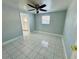 Bright bedroom with tile flooring and ceiling fan at 1415 Weyford Ln, Holiday, FL 34691