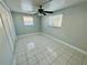 Bright bedroom with ceiling fan and tiled floors at 1415 Weyford Ln, Holiday, FL 34691
