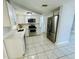 Updated kitchen featuring stainless steel appliances and white cabinets at 1415 Weyford Ln, Holiday, FL 34691