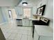 Modern kitchen with white cabinets and stainless steel appliances at 1415 Weyford Ln, Holiday, FL 34691