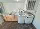 Laundry room with washer, dryer, and cabinets at 1415 Weyford Ln, Holiday, FL 34691
