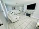 Modern living room with a white sectional sofa and fireplace at 1415 Weyford Ln, Holiday, FL 34691