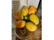 Crystal bowl filled with ripe mangoes and limes at 1415 Weyford Ln, Holiday, FL 34691