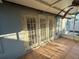Screened porch with access to backyard at 1415 Weyford Ln, Holiday, FL 34691