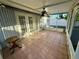 Screened porch with tile flooring and ceiling fan at 1415 Weyford Ln, Holiday, FL 34691
