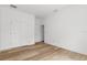 Simple bedroom with wood-look floors and double doors at 16434 Medley Rd, Weeki Wachee, FL 34614