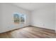Simple bedroom with large window and wood-look floors at 16434 Medley Rd, Weeki Wachee, FL 34614