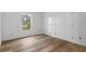 Well-lit bedroom with wood-look floors and double doors at 16434 Medley Rd, Weeki Wachee, FL 34614