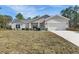 Charming single-story home with a well-manicured lawn and a two-car garage, showcasing great curb appeal at 16434 Medley Rd, Weeki Wachee, FL 34614