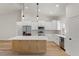 Modern kitchen with stainless steel appliances, white cabinets, a wooden kitchen island, and light hardwood floors at 16434 Medley Rd, Weeki Wachee, FL 34614