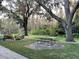 Relaxing community backyard with picnic table under tree at 1761 Cupecoy Cir # N-1, Lutz, FL 33558