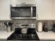 Stainless steel microwave and range in updated kitchen at 1761 Cupecoy Cir # N-1, Lutz, FL 33558