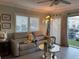 Living room with gray sectional and glass coffee table at 1761 Cupecoy Cir # N-1, Lutz, FL 33558