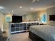 Main bedroom with TV and built-in shelving at 1761 Cupecoy Cir # N-1, Lutz, FL 33558
