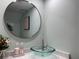 Stylish bathroom featuring a glass sink and round mirror at 1761 Cupecoy Cir # N-1, Lutz, FL 33558