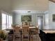 Bright dining area with wood table and chairs, showcasing artwork at 1761 Cupecoy Cir # N-1, Lutz, FL 33558