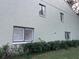 Light green building with white shutters and landscaping at 1761 Cupecoy Cir # N-1, Lutz, FL 33558
