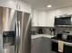 Stainless steel appliances and gray cabinets highlight this kitchen at 1761 Cupecoy Cir # N-1, Lutz, FL 33558