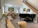 Spacious living room featuring a piano, comfortable seating, and large windows at 1761 Cupecoy Cir # N-1, Lutz, FL 33558