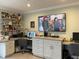 Home office with two workstations, ample storage, and a large TV at 1761 Cupecoy Cir # N-1, Lutz, FL 33558