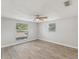 Bright bedroom with wood-look tile flooring and ceiling fan at 17750 Oxenham Ave, Spring Hill, FL 34610