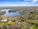 Wide aerial showcasing a lakefront community with various houses at 18104 Spencer Rd, Odessa, FL 33556