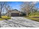 House exterior showcasing a two-car garage and a spacious driveway at 18104 Spencer Rd, Odessa, FL 33556