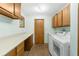 Laundry room with washer, dryer, and cabinets at 18104 Spencer Rd, Odessa, FL 33556