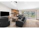 Spacious living room with a fireplace and access to a patio at 18104 Spencer Rd, Odessa, FL 33556