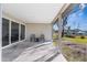 Covered patio with seating area overlooking backyard at 18104 Spencer Rd, Odessa, FL 33556