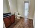 Powder room with granite vanity and tiled floor at 18501 Cypress Bay Pkwy, Land O Lakes, FL 34638