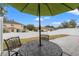 Relaxing backyard patio with seating area and umbrella, perfect for outdoor dining at 194 Argyll Dr, Spring Hill, FL 34609