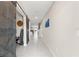 Bright entry hall with tile floors and barn doors leading to other rooms at 194 Argyll Dr, Spring Hill, FL 34609